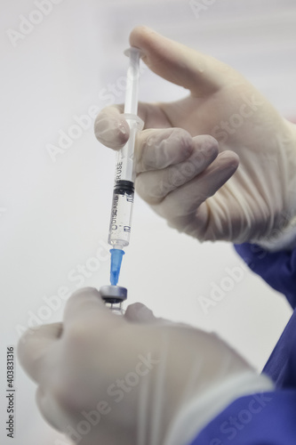 Shallow depth of field (selective focus) image with details of Covid- 19 vaccine administration in the hospital.