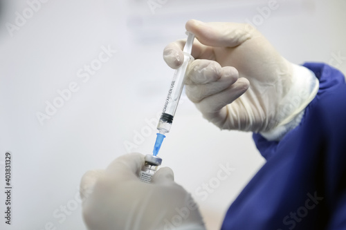 Shallow depth of field (selective focus) image with details of Covid- 19 vaccine administration in the hospital.