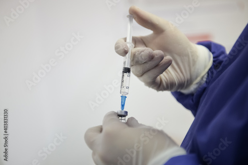 Shallow depth of field (selective focus) image with details of Covid- 19 vaccine administration in the hospital.