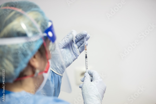 Shallow depth of field (selective focus) image with details of Covid- 19 vaccine administration in the hospital.