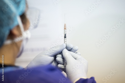 Shallow depth of field (selective focus) image with details of Covid- 19 vaccine administration in the hospital.