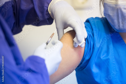 Shallow depth of field (selective focus) image with details of Covid- 19 vaccine administration in the hospital.
