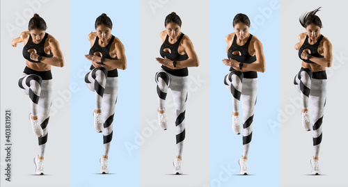 Sporty woman running. Isolated on grey background