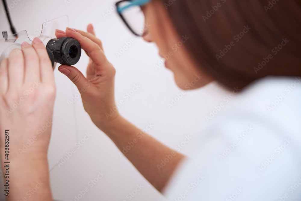Fototapeta premium Medical person is regulating a slit lamp
