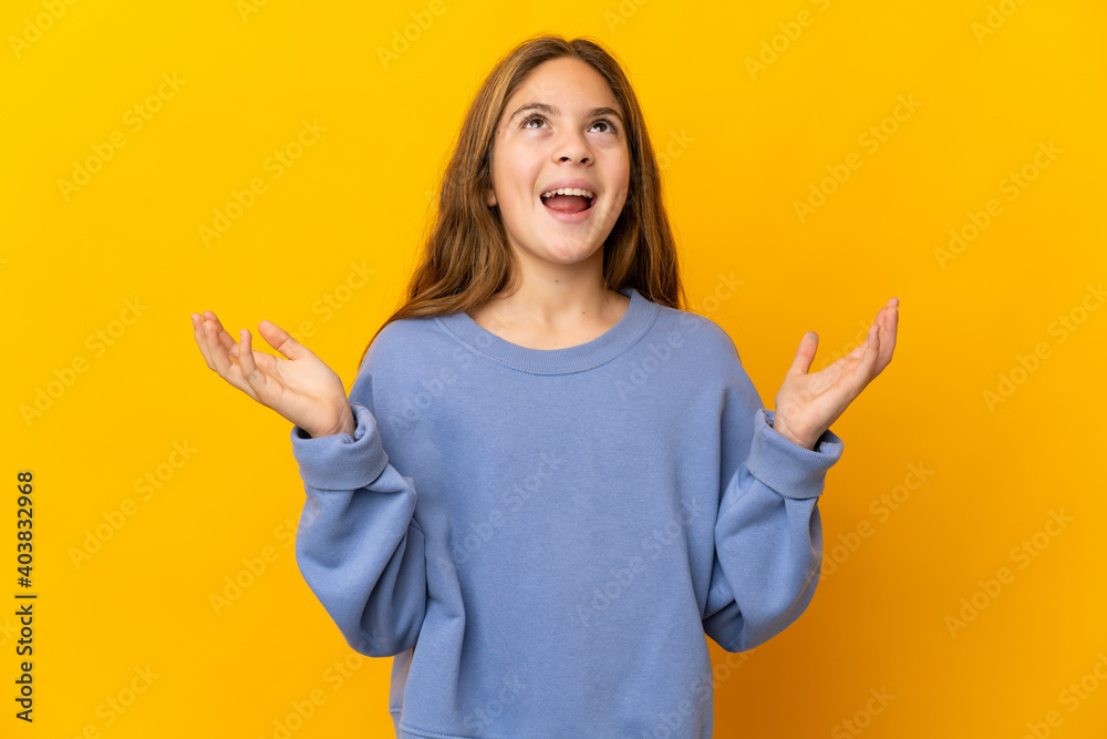 Child over isolated yellow background smiling a lot Child over isolated yellow background smiling a lot