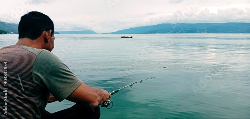 man fishing on the lake