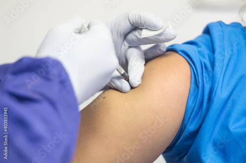 Shallow depth of field (selective focus) image with details of Covid- 19 vaccine administration in the hospital.
