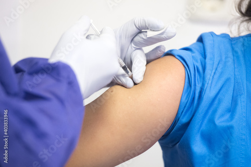 Shallow depth of field (selective focus) image with details of Covid- 19 vaccine administration in the hospital.
