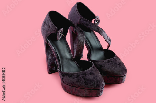 Women`s platform shoes on a pink background. Punk, grunge, goth women shoes.