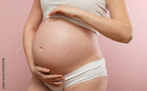 Pregnant woman holding her belly © rubchikova