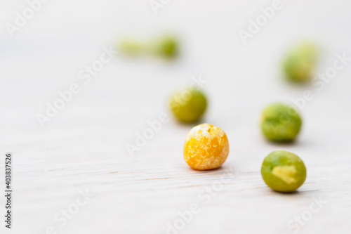 green and yellow peas on white background