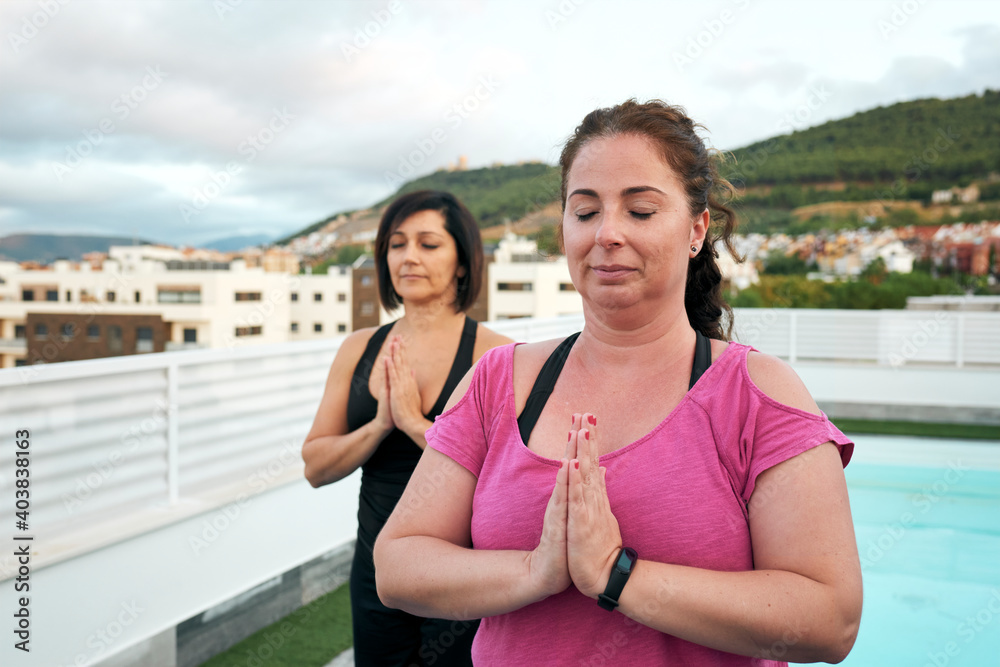 women do yoga on the terrace of the house, namaste greeting women do yoga on the terrace of the house, namaste greeting