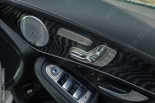 Closeup shot of a modern car door handle interior details with controls and adjustments photo