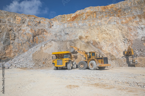 loader loading mining truck at open pit