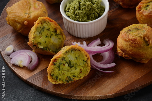 Batata vada popular street food of India, Served with green chutney.