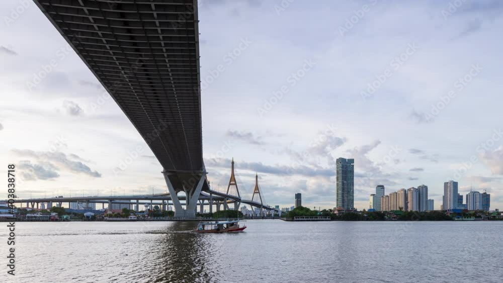 Large suspension bridge over Chao Phraya river at twilight, day to night - time lapse Large suspension bridge over Chao Phraya river at twilight, day to night - time lapse