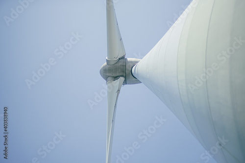 bottom view of wind turbine against sky