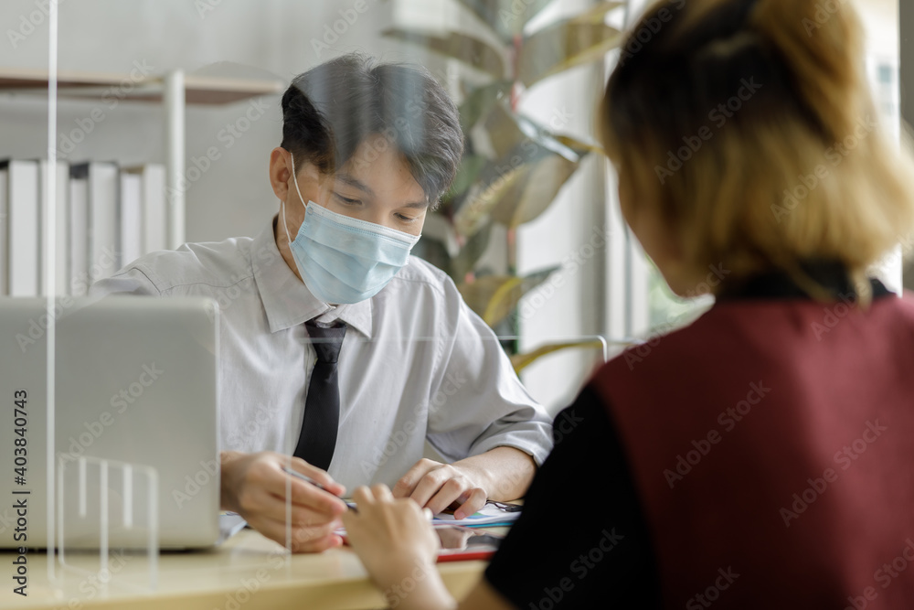 business man workers wearing face mask and clear shield having discussion through glass partition at the office business man workers wearing face mask and clear shield having discussion through glass partition at the office