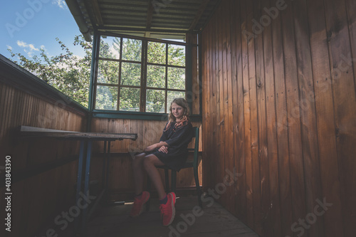 child sitting in lounge of wooden cottage