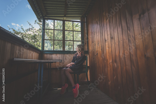 child sitting in lounge of wooden cottage