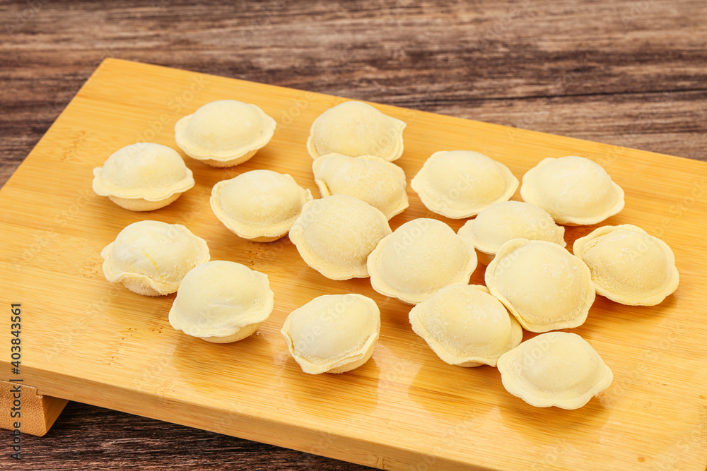 Raw dumplings over board for cooking Raw dumplings over board for cooking