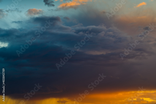 Sunset sky with beautiful black and orange clouds (background) 