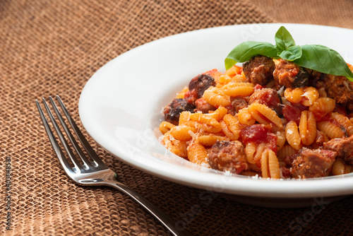 Fototapeta Naklejka Na Ścianę i Meble -  Malloreddus alla campidanese, tipica pasta sarda con sugo di salsiccia, Cibo Italiano