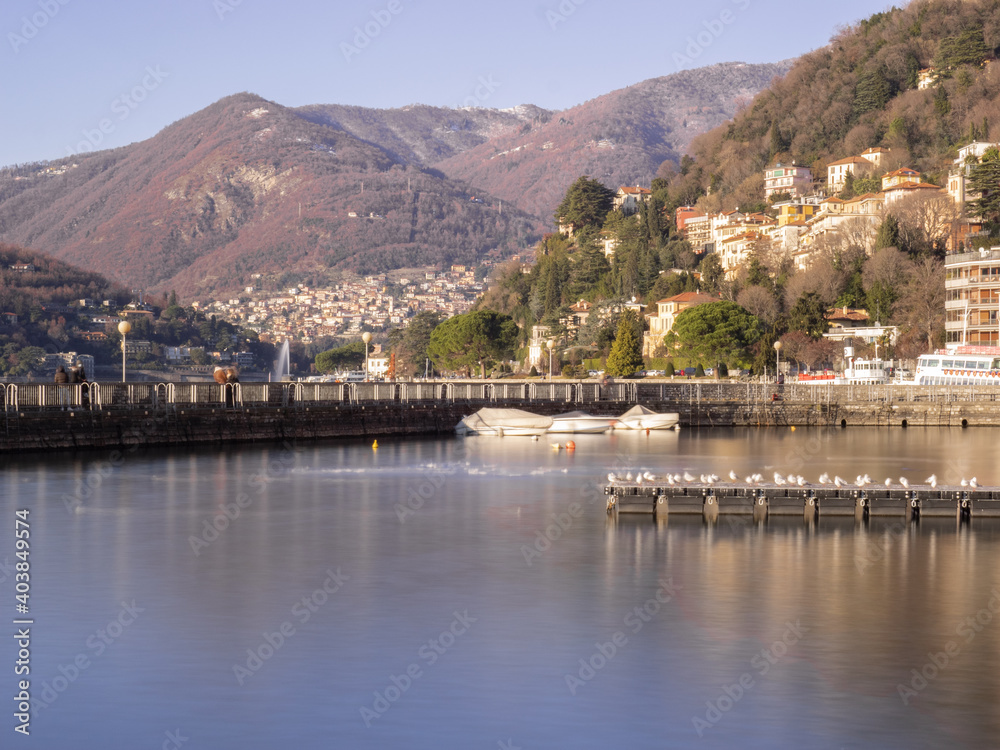 panoramic cityscape of como harbor in a mild and sunny winter day.Como lake, lombardy, italian lakes, Italy.