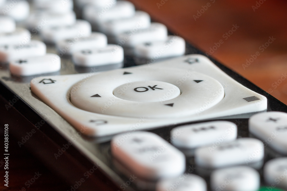 White OK button on the black TV remote control White OK button on the black TV remote control