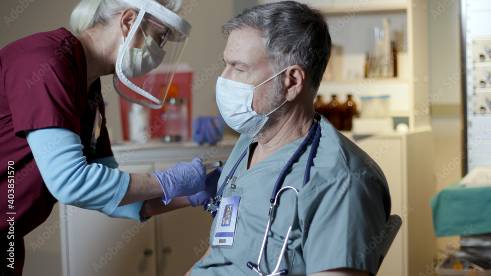 doctor getting the covid-19 vaccine in hospital