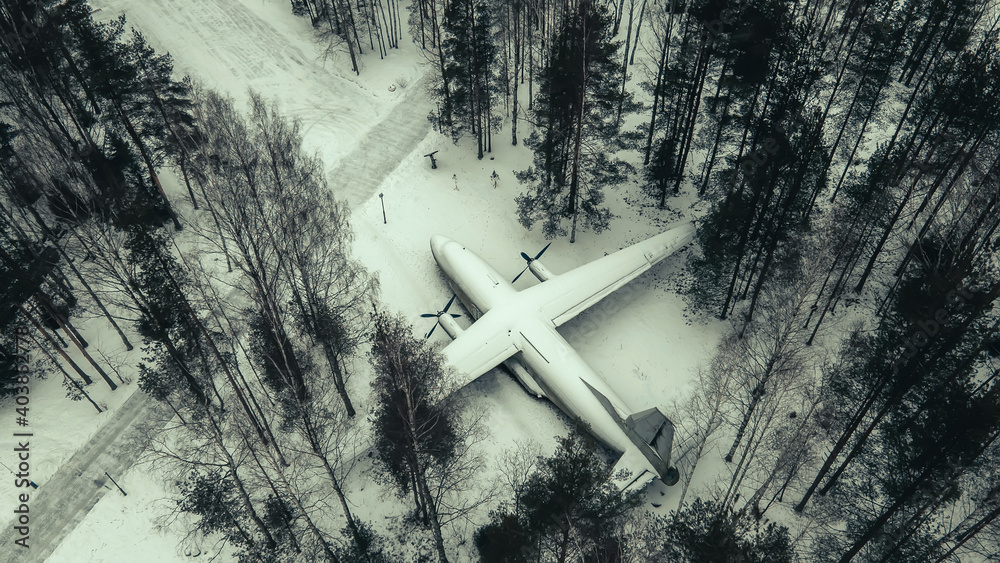 Abandoned aircraft in the winter forest. Snowy trees. Fallen old aircraft Abandoned aircraft in the winter forest. Snowy trees. Fallen old aircraft
