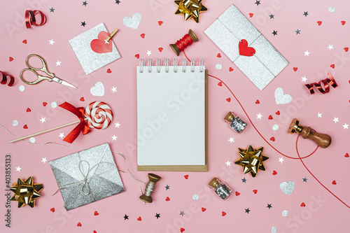 Valentine's Day mock up. Notepad mockup surrounded by decorations for valentine's day..Gifts, letters and hearts on a pink background.Flat lay with copy space.The concept of love.