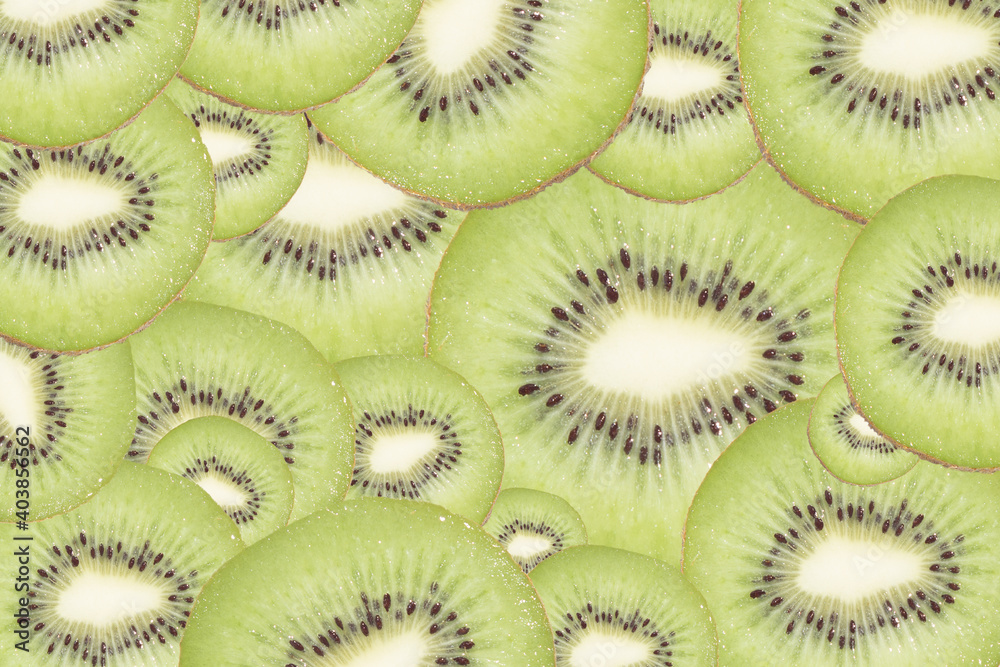 Slices of kiwi as textured background, close up and top of view. Slices of kiwi as textured background, close up and top of view.