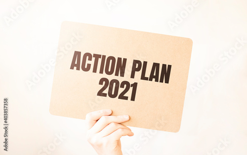 Closeup Business man hand holding show blank paper sheet mock up empty white board space for shouting text rule or protest word. Text ACTION PLAN 2021