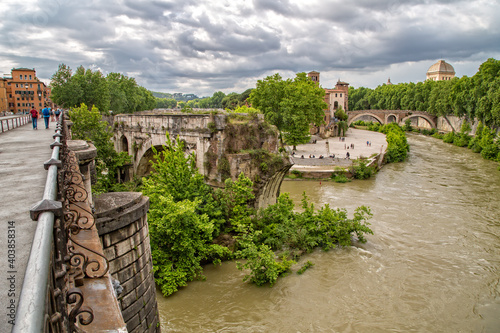 Fototapeta Naklejka Na Ścianę i Meble -  Panoramic view of the Pons Aemilius and Tiber island. View of the ancient Ponte Rotto or Pons Aemilius with Isola Tiberina in the background, Rome, Italy