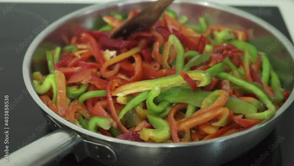 Removing peppers in a frying pan. Kitchen concept. Removing peppers in a frying pan. Kitchen concept.