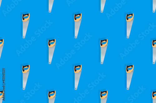 Hand saw seamless pattern on a blue background.