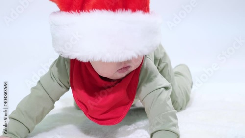 Adorable baby dressed in a Christmas red hat