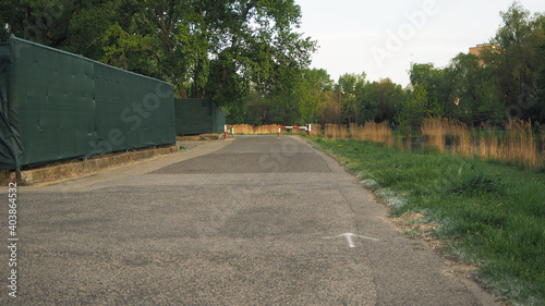 Photography Sunny road in the park near water.