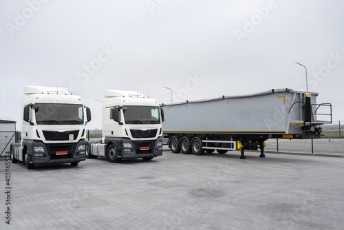 Trucks and trailer in the parking lot. Loading in an industrial park. Logistic and transport concept