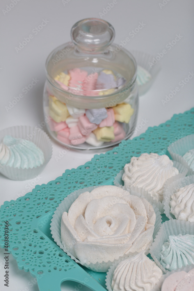 Zephyr in a jar and on a tray. Various shapes and shades. Close-up shot. Zephyr in a jar and on a tray. Various shapes and shades. Close-up shot.