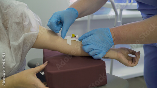 The doctor injects the patient into a vein. Close up - blood test from a vein of the arm. Intravenous anesthesia.