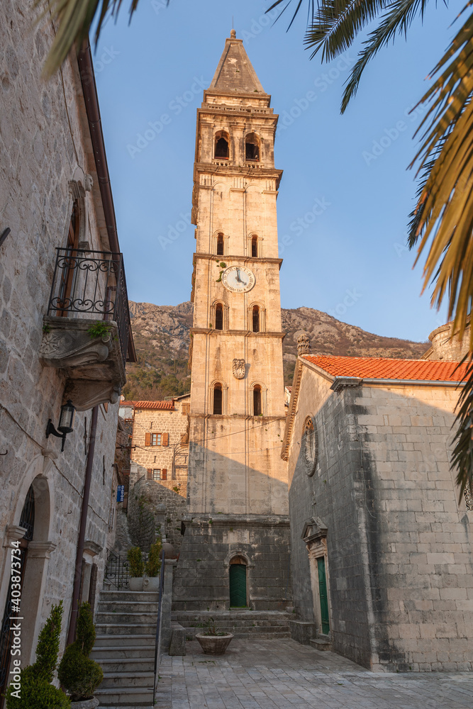 Clock tower of St. Nicholas Church in Perast town at evening light, Montenegro
