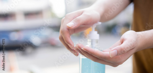 close up adult man pressing on sanitizer bottle to washing and rubbing hand to cleaning for protect virus and prevent coronavirus (MERS-n COV) and bacteria concept	 photo