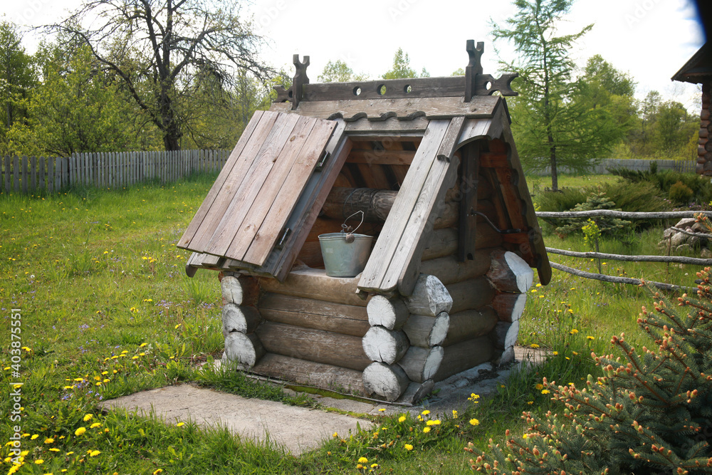 Naklejka premium An old wooden well in the village