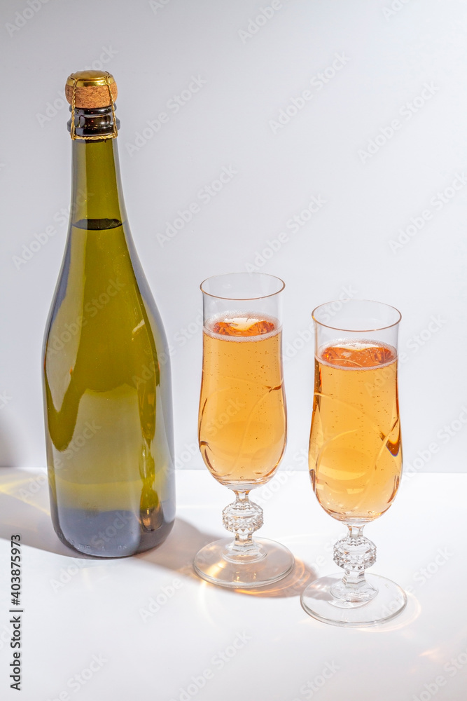 Green bottle with champagne inside and two glasses with champagne Green bottle with champagne inside and two glasses with champagne