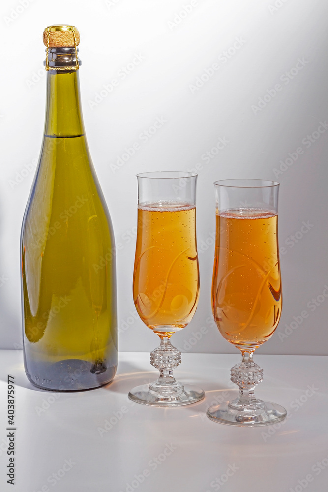 Green bottle with champagne inside and two glasses with champagne Green bottle with champagne inside and two glasses with champagne