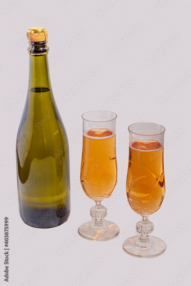 Green bottle with champagne inside and two glasses with champagne Green bottle with champagne inside and two glasses with champagne