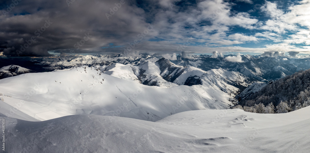 Fototapeta premium Black clouds are approaching the snowy mountains.