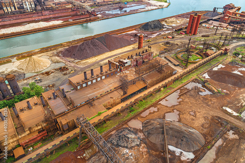 Aerial View of Vast Industrial Landscape. Steel Mills and Heavy Industry, Rail Lines, Bridges, Shipping Canal, Harbor, etc.